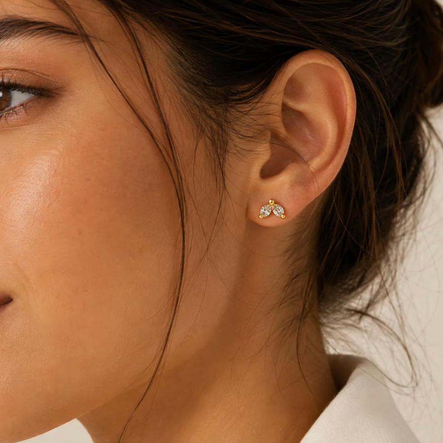 White enamel gold C-hoop earrings on pure white background