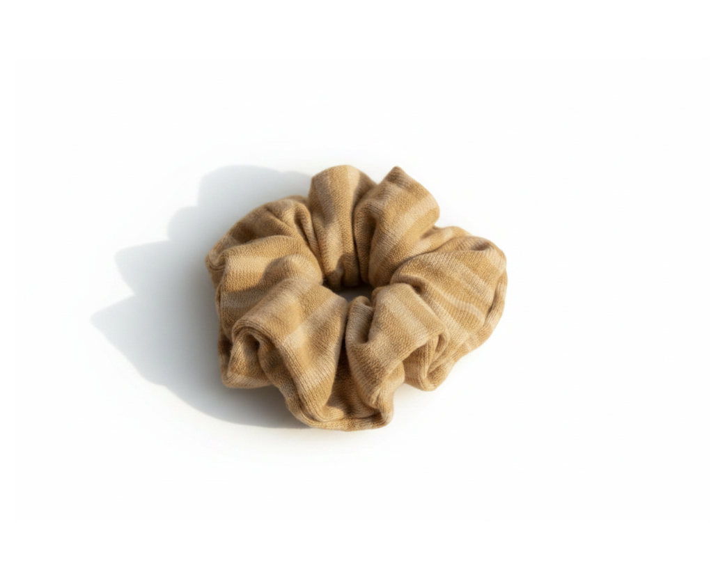 Soft beige velvet scrunchie on white background