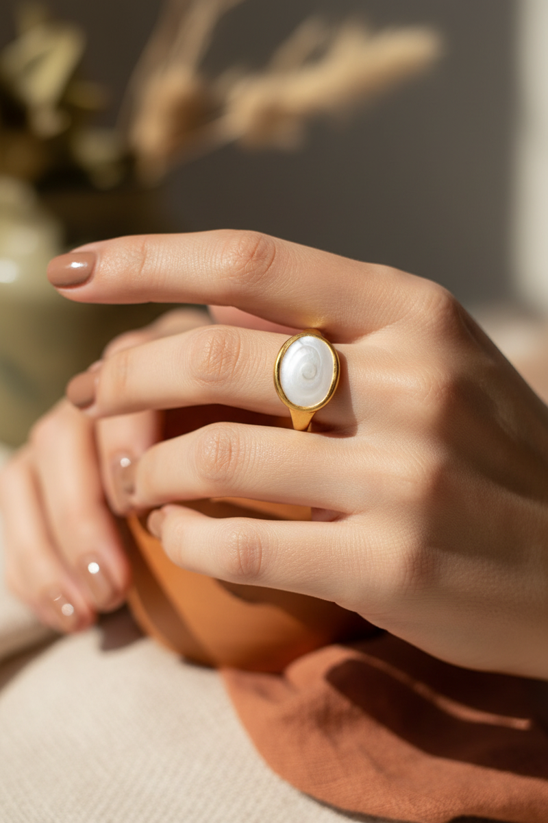 Model wearing white shell spiral ring