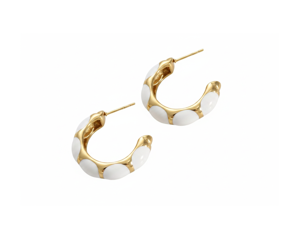 White enamel gold C-hoop earrings on pure white background