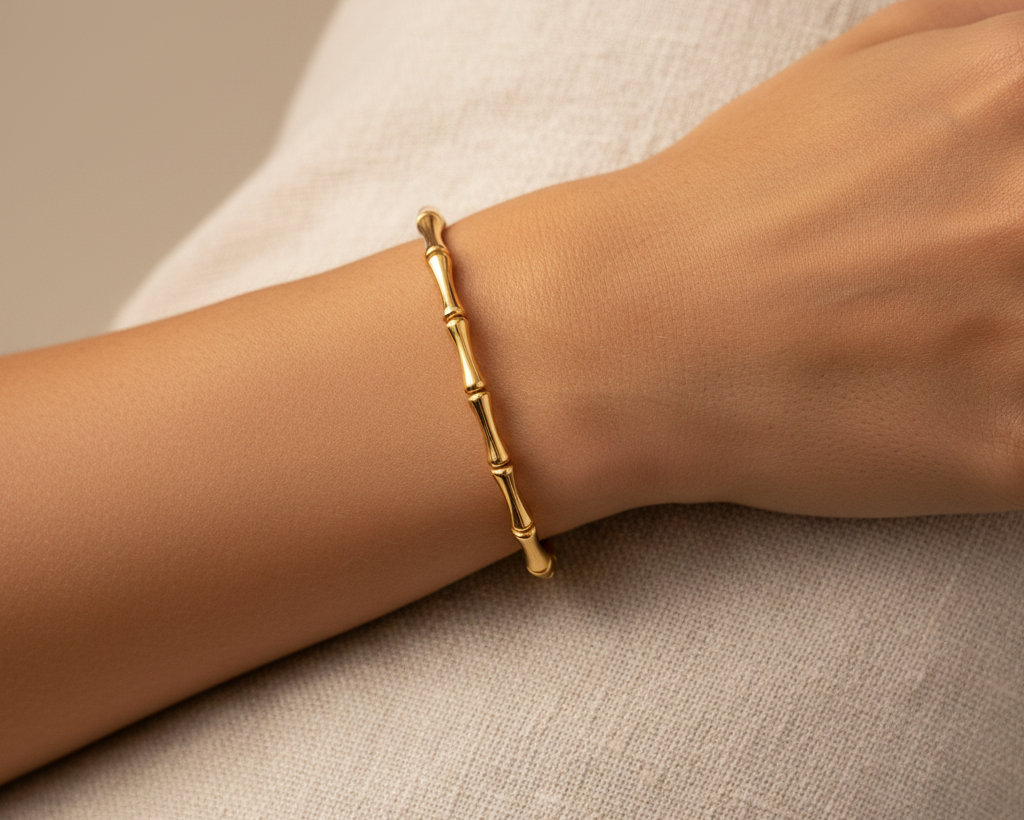 Gold bamboo bangle bracelet worn on wrist, editorial lifestyle shot
