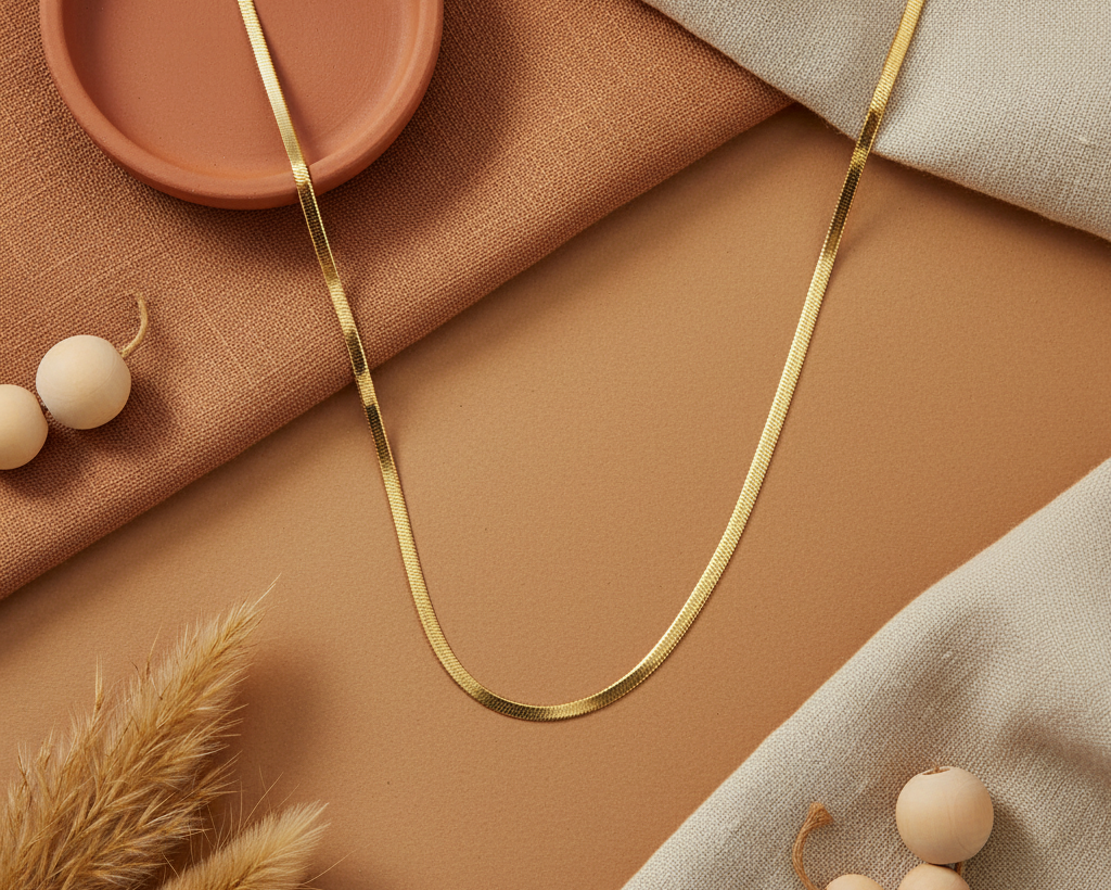 Gold herringbone snake chain necklace on boho earthy background