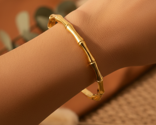 Model wearing Aurora Bamboo Gold Cuff Bangle